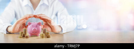 Protecting Your Savings - Banking And Assurance Concept - Hands Over Piggybank With Money Stacks Stock Photo