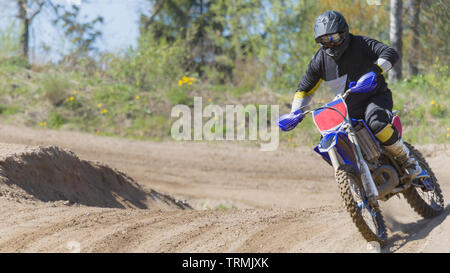 Race leading motocross rider on dirt track circuit Skallsjöbanan in Floda, Sweden taking a corner Stock Photo