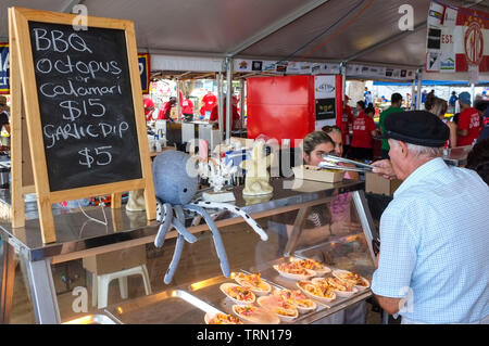 Man buying food at the Glenti Greek Festival in Darwin, Northern Territory, Australia. Stock Photo