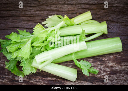 Fresh vegetable of Celery sticks and leaf / Bunch of celery stalk on rustic wood background Stock Photo