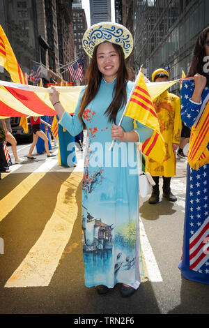 A beautiful Vietnamese American woman in a traditional AO DAI dress at the Vietnamese American Cultural Parade in Midtown Manhattan, New York City. Stock Photo