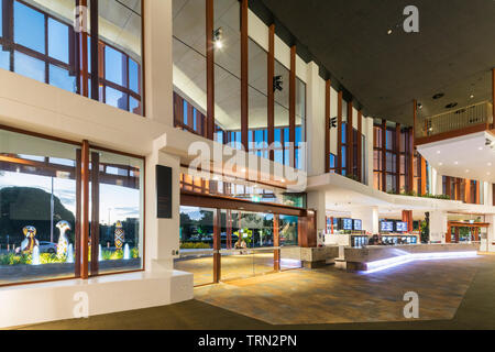 The foyer of the Cairns Performing Arts Centre illuminated at twilight, Cairns, Queensland, Australia Stock Photo