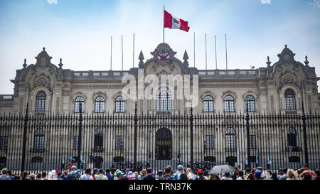 Lima, Peru - April 7, 2018: Tourists watch the Changing of the guards ceremony outside the Peruvian Government Palace Stock Photo