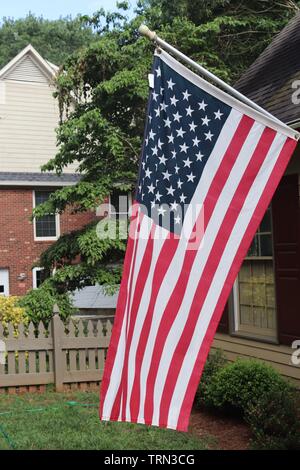 American flag hanging from a front porch Stock Photo