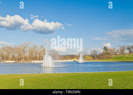 The remnant of rain clouds trail away from the Grand Basin and its fountains at St. Louis Forest Park on an April afternoon. Stock Photo
