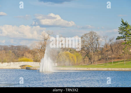 The remnant of rain clouds trail away from the Grand Basin and its fountains at St. Louis Forest Park on an April afternoon. Stock Photo