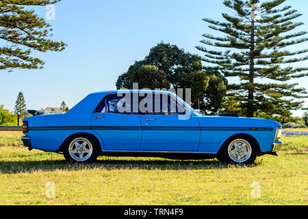 Port Adelaide, South Australia - October 14, 2017: Side view of iconic Australian made Ford Falcon 351-GT parked on the grass on a day Stock Photo