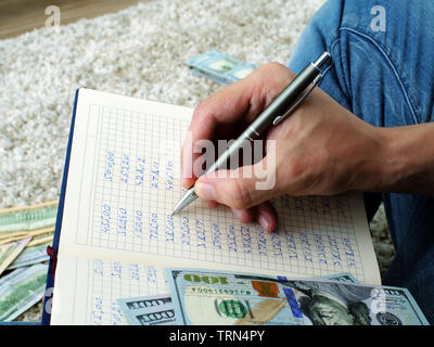 Man is calculating monthly home budget and expenses. Stock Photo