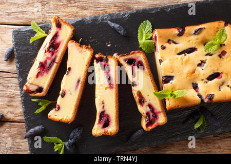 Summer honeysuckle pie sliced on a board closeup on the table. horizontal top view from above Stock Photo