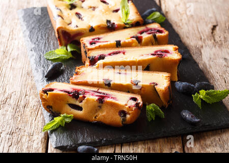 Homemade bread with honeysuckle and mint on the board closeup on a wooden table. horizontal Stock Photo