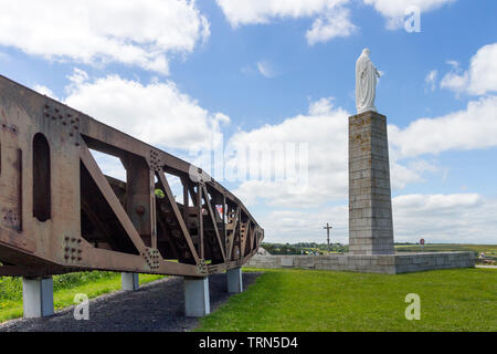 Sections of the Mulberry Harbour at the Royal Engineers War Memorial with Statue of the Virgin Mary Overlooking D-Day Beaches at Arromanches-les-Bains Stock Photo