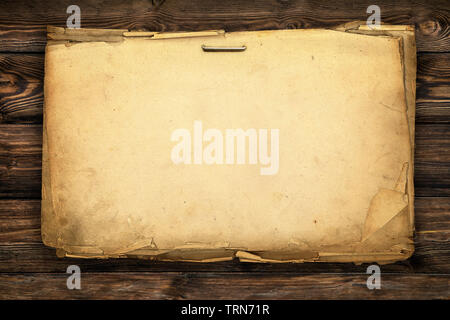 Blank sheets of old/ vintage paper nailed to a dark wooden wall. Stock Photo