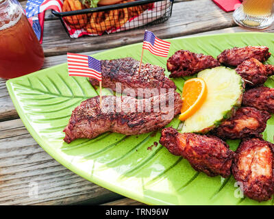 Beef steak with chicken wings and fruits, top view Stock Photo