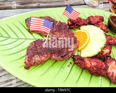 Beef steak with chicken wings and fruits, top view Stock Photo