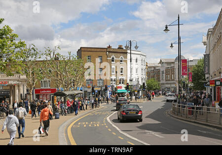 Wimbledon town centre, southwest London crowded with shoppers on a busy, summer Saturday. View east along Wimbledon Broadway. Stock Photo