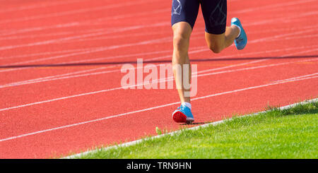 Young sporty man running on sunny day Stock Photo