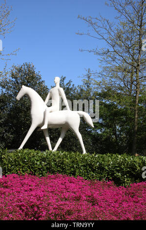 View of a white sculpture of a man on horseback in Keukenhof Gardens near Lisse in South Holland, Netherlands on a sunny spring day in 2019. Stock Photo