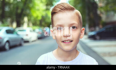 Portrait of happy boy with cool hipster haircut - Charming young casual smiling kid with trendy hairstyle - man fashion concept Stock Photo