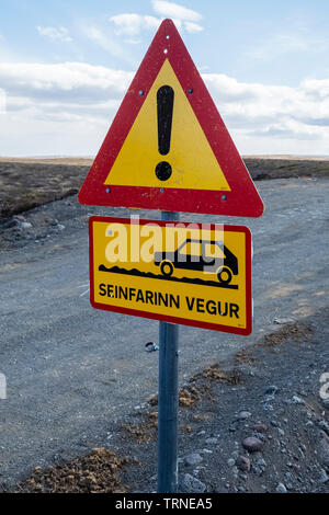 North Iceland. A road sign warning of an unsurfaced gravel road ahead (Seinfarinn Vegur or Bad Surface) Stock Photo