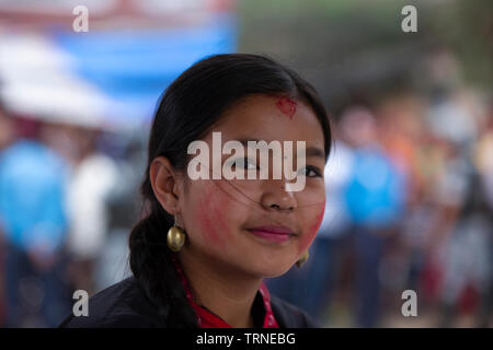 Kathmandu, Nepal, 09 June, 2019. Girl smear the red color in her face during the Rato Machindranath Festival. Sarita khadka/Alamy Live News Stock Photo