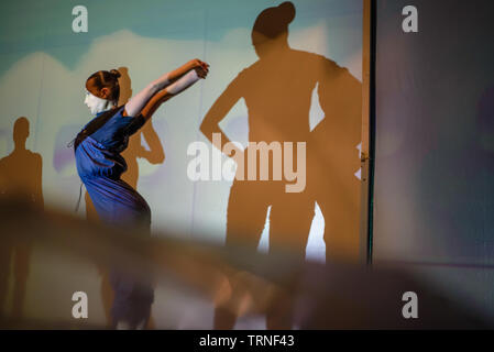 Artists of Teulis Shadow Theater during the performance in Kiev, Ukraine. Artists of the theater create performances using the flexibility and plasticity of their own body. Stock Photo