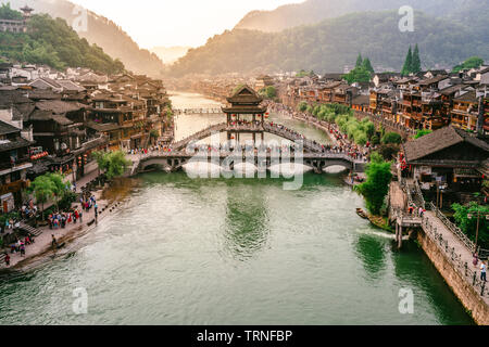 2 June 2019, Fenghuang China : Tuo Juang river scenery with antique bridge and dramatic light in Fenghuang phoenix town in Hunan China Stock Photo