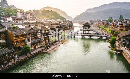 2 June 2019, Fenghuang China : Tuo Jiang river panorama with antique bridge and dramatic light in Fenghuang phoenix town in Hunan China Stock Photo