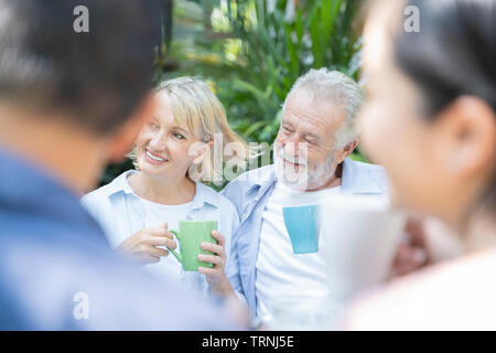 Happy moments. Joyful retirement age nice couple having tea and laughing while enjoying their time together - Image Stock Photo