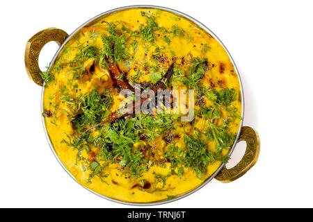 Kadhi Pakoda or pakora, Indian cuisine, served in a brass kadai or bowl isolated on white background. Stock Photo