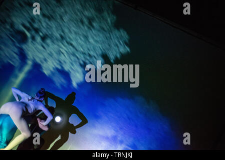 Artists of Teulis Shadow Theater during the performance in Kiev, Ukraine. Artists of the theater create performances using the flexibility and plasticity of their own body. Stock Photo