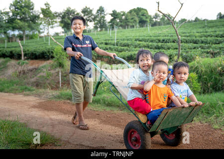 Bao Loc, Lam Dong province, Vietnam - Jun 1, 2019: Rural children play on strollers in Bao Loc, Lam Dong province, Vietnam Stock Photo