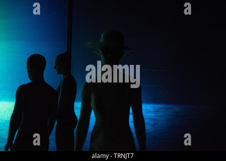 Artists of Teulis Shadow Theater during the performance in Kiev, Ukraine. Artists of the theater create performances using the flexibility and plasticity of their own body. Stock Photo