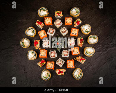 A large set of fresh rolls in the Japanese style on a dark background, top view Stock Photo