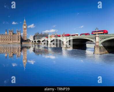 Big Ben and Houses of Parliament with red buses on the bridge in London, England, UK Stock Photo