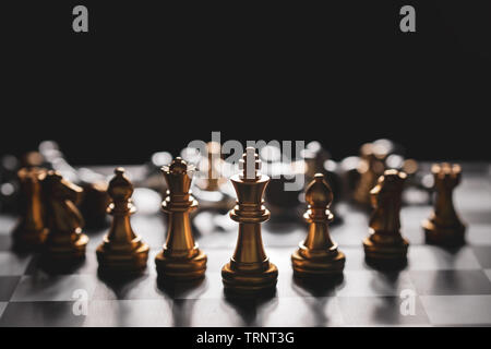 Golden Chess game strategy winner on chessboard,Business planing strong concept with dark background. Stock Photo