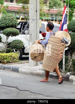 Bangkok, Thailand - May 12, 2019 : Vender Carrying and Selling Handmade Bamboo Wicker Baskets on The Road. Stock Photo