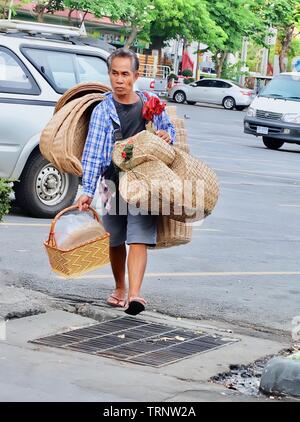 Bangkok, Thailand - May 12, 2019 : Vender Carrying and Selling Handmade Bamboo Wicker Baskets on The Road. Stock Photo