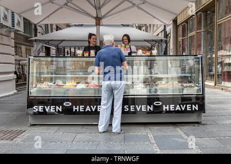 Belgrade, Serbia, June 6th 2019: Man buying from an ice cream stand at Knez Mihailova Street Stock Photo