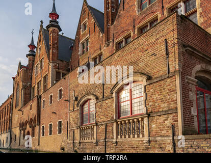 Canal side exterior view of Landhuis van het Brugse Vrije (Palace of the Liberty of Bruges) in Bruges, Belgium. Cityscape of Bruges streets shot from Stock Photo