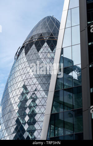 The Gherkin Building at 30 St Mary Axe in the City of London UK, visible behind the Willis building on Lime Street. Stock Photo