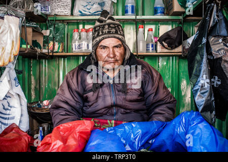 Bolivian Market Seller in the town of Potosí selling mining supplies as well as cocoa leaves to the miners in the nearby mines. Stock Photo