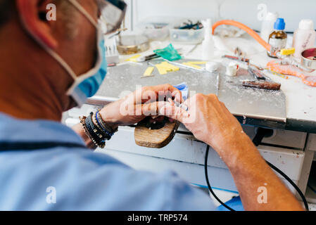 Caucasian man working on a dental prosthesis Stock Photo
