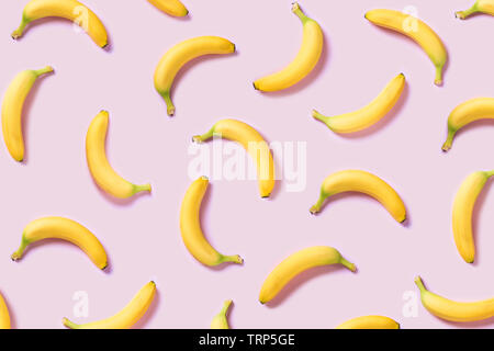 Yellow bananas pattern on pink background Stock Photo