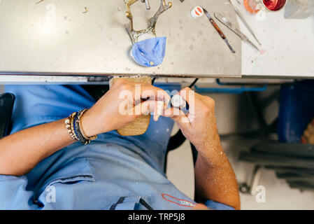 Caucasian man working on a dental prosthesis Stock Photo