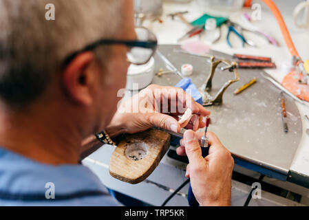 Caucasian man working on a dental prosthesis Stock Photo