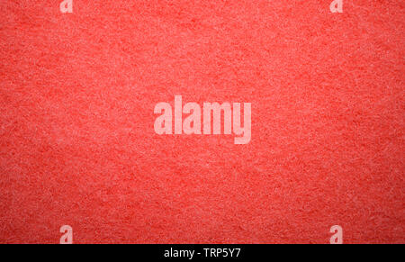 Texture of surface of unused red sponge closeup. The concept of hygiene and cleanliness. Sponge for dishes, for cleaning. Close-up Stock Photo