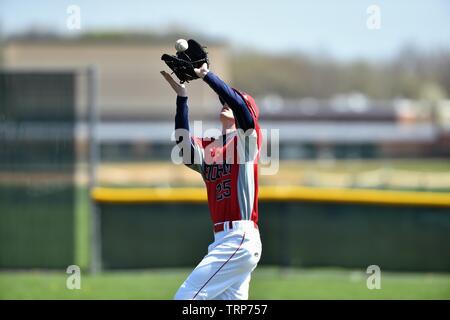 Outfielder running back to make an over the shoulder catch of a fly ball. USA. Stock Photo