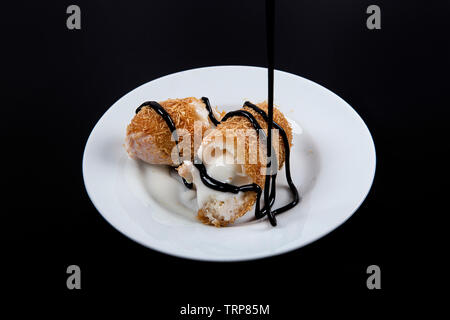 Delicious Turkish dessert. Fried ice-cream covered with chocolate Kadayif. Stock Photo