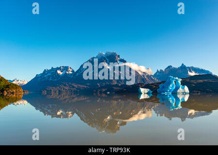 Sunrise reflection by Lago Grey with the famous Andes peaks of the Torres del Paine national park, Patagonia, Chile. Stock Photo