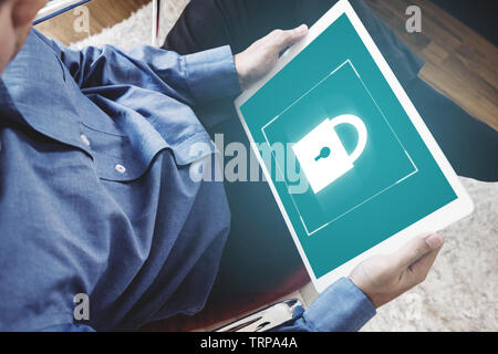Mobile device security system. a man using digital tablet and lock icon on screen Stock Photo